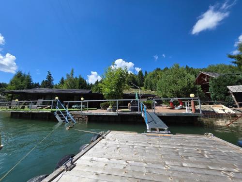 a dock with a boat in the water at Echilibru in Colibiţa