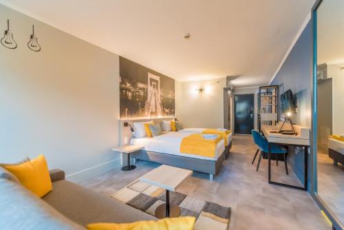 a hotel room with a bed and a desk at Impulso Fashion Hotel in Budapest
