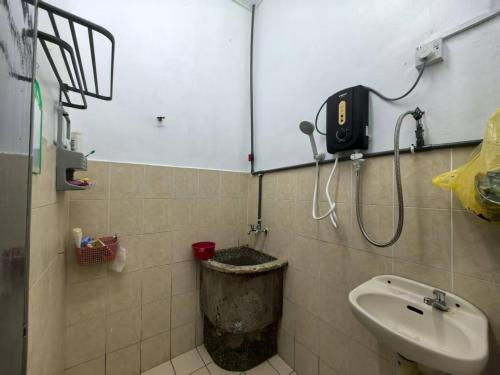 a bathroom with a sink and a shower at Queen Bed Budget Room in Padang Serai