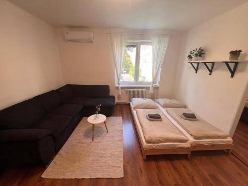 a living room with a couch and a large bed at Rose Valley in Bratislava