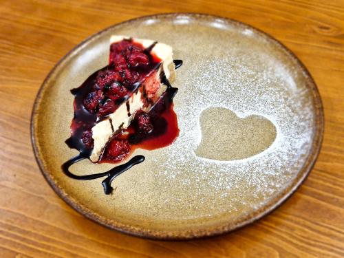 a piece of cake on a plate with a heart on it at Country Saloon Belá in Belá