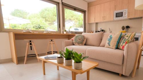 a living room with a couch and a table at Apartamentos Costa Norte in San Vicente de la Barquera