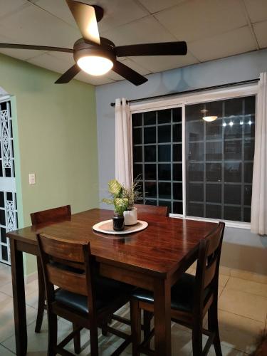 a dining room table with chairs and a ceiling fan at Costa Verde Room With Private Bathroom in Alto de Limón