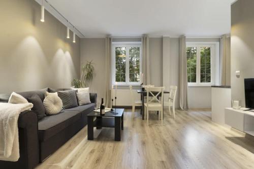 a living room with a couch and a table at Elite Apartments Old Town Center in Gdańsk