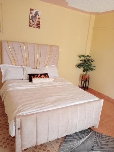 a white bed with a fireplace in a bedroom at Voi luxurious homes in Voi