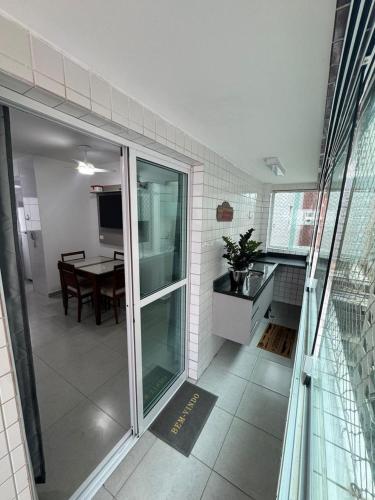 a small kitchen and dining room with a table at Vista Mar 111 in Praia Grande