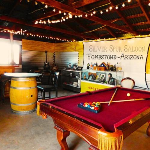 a room with a pool table and a barrel at Silver Spur Homestead Luxury Glamping - The Cowboy in Tombstone