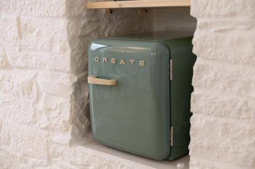 a green suitcase is sitting on a shelf at AD CALCEM Antiche Dimore Lagodentro in Terlizzi