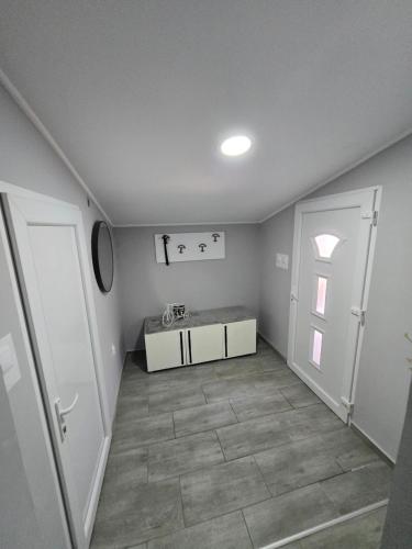 an empty hallway with a room with a door at OneDay Apartment in Subotica