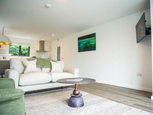 a living room with a white couch and a table at Dingle Bay Haven in Dingle