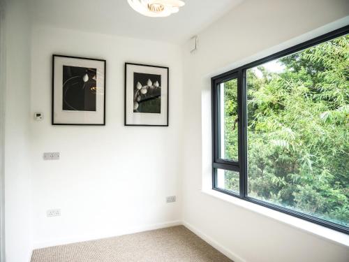 a room with three pictures on the wall and a window at Dingle Bay Haven in Dingle