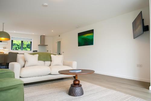 a living room with a white couch and a table at Dingle Bay Haven in Dingle