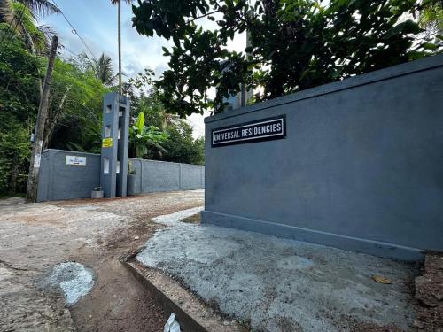 a sign on a wall that reads human batteries at The Glory Villa Transit Hotel in Katunayake