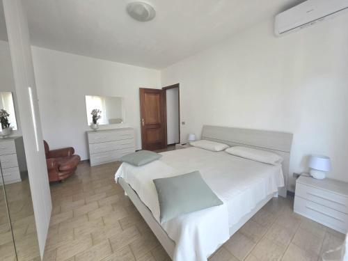 a white bedroom with a large bed and a mirror at AXIS Apartments Terni Essence in Terni