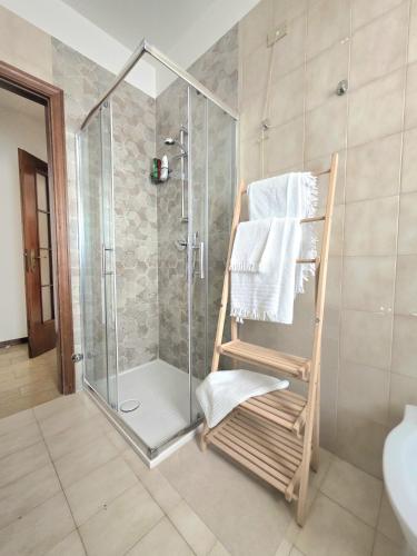 a bathroom with a shower with a towel rack at AXIS Apartments Terni Essence in Terni