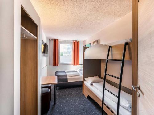 a small room with two bunk beds in it at B&B Hotel Freiburg-Nord in Freiburg im Breisgau