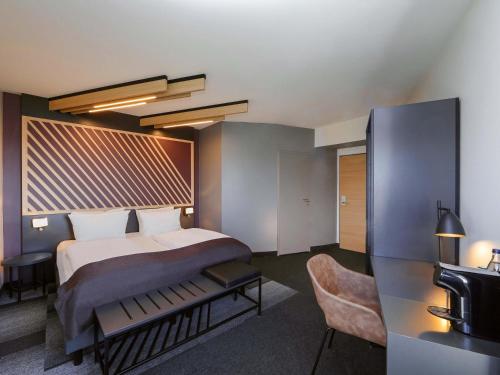 a hotel room with a bed and a television at B&B Hotel Berlin-Airport in Schönefeld
