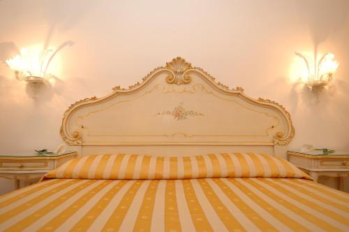 a bed with an ornate headboard in a bedroom at Casa Sul Molo in Venice