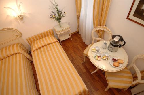 a room with two beds and a table with a tea set at Casa Sul Molo in Venice