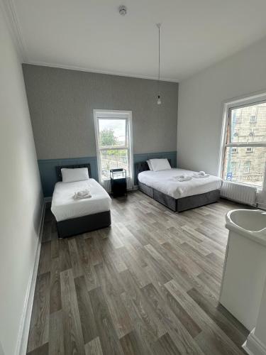 a room with two beds and a tub in it at Saint Annes Guest House - 22 Berkeley in Dublin
