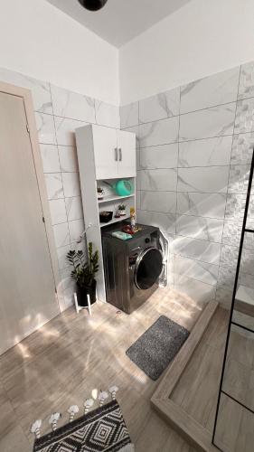 a kitchen with a washing machine in a room at Heraklia villa sea view pool & jacuzzi in Nea Iraklia