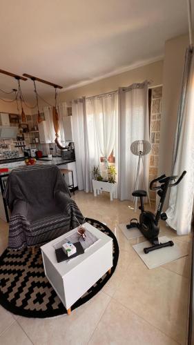a living room with a couch and a table at Heraklia villa sea view pool & jacuzzi in Nea Iraklia