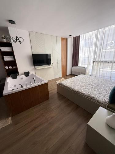 a bedroom with a bed and a bath tub at Luxury Suite21 in Korçë