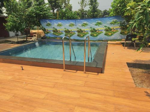 a swimming pool with a banner on top of it at Siva Rama garden resort & swimming pool 5star stay comfort 6BHK bheemili beach road nr in Visakhapatnam