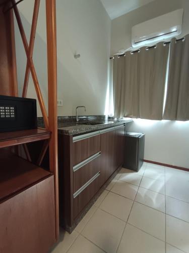 a kitchen with a sink and a counter top at Pousada Porto do Sol in Pôrto Rico