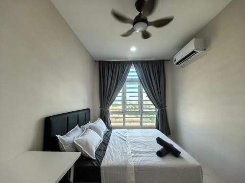 a bedroom with a bed with a ceiling fan and a window at Ipoh Town 2224 six pax By Hopestay in Ipoh