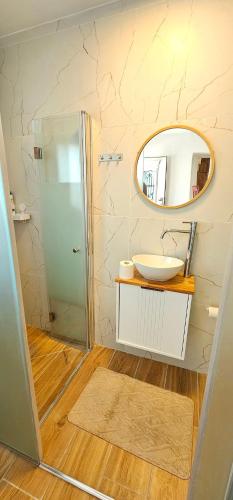 a bathroom with a sink and a mirror at Zimmer Belev HaKikar- Dead sea in Neʼot HaKikar