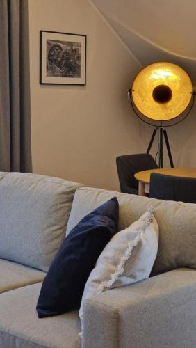 a couch with two pillows on it in a living room at Moderne Wohnung - renoviert 2024 in Solingen