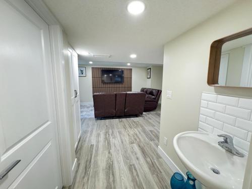 a bathroom with a sink and a living room at Annas Suites Rental in Bélanger