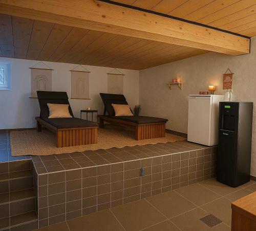 a living room with two beds and a refrigerator at Chalet Oz in Vitznau