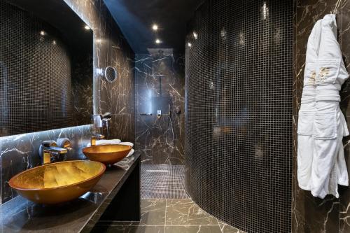 a bathroom with two wooden sinks and a shower at H Hotel & SPA - Adults Only in St Julian's
