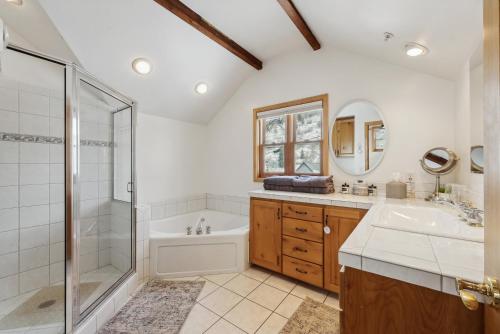 a bathroom with a shower and a tub and a sink at Cozy Hillside Cottage Overlooking Main Street in Park City