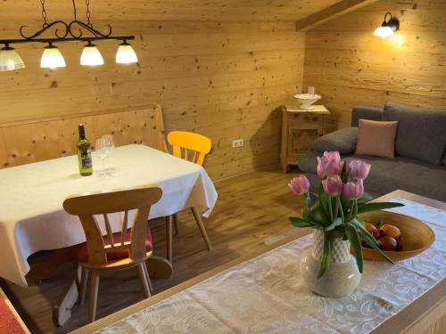 a living room with a table and a couch at Aussermooserhof in Alpbach
