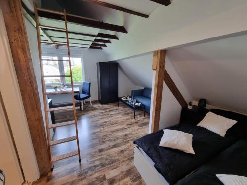 a bedroom with a loft bed and a ladder at CJS Apartments - Chill or Drive am Nürburgring, Free Parking, WLan, Spacious Rooms, Quiet Location in Rodder
