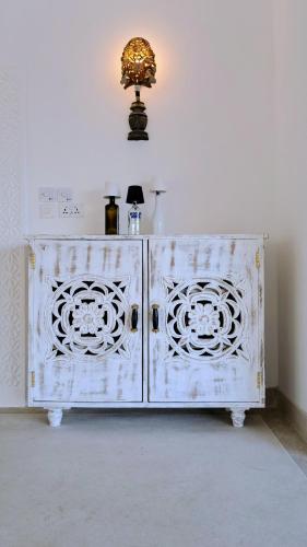 a white cabinet with a light on top of it at Beba.Beach.House in Watamu