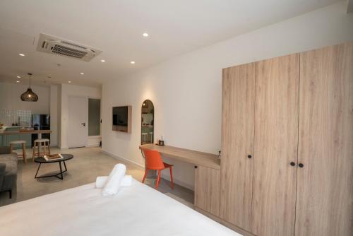 a bedroom with a bed and a wooden cabinet at COMMON INN Thu Dau Mot in Ga Phú Văn