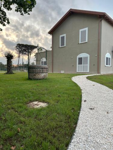 a house with a walkway in front of a yard at Peacock apartments Latina in Latina