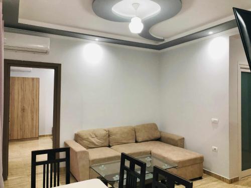 a living room with a couch and a glass table at Apartments panoramic Ana in Sarandë