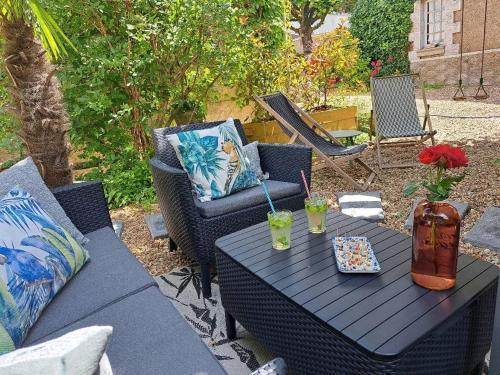 a black table and chairs on a patio at gite Chezelle in Saint-Georges-sur-Cher