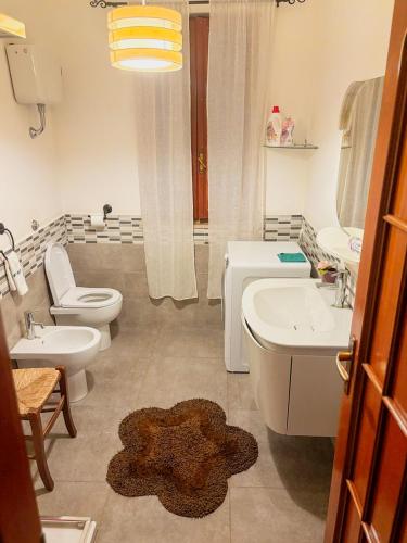 a bathroom with a toilet and a sink and a tub and a toilet at Villino Emma in Santadi
