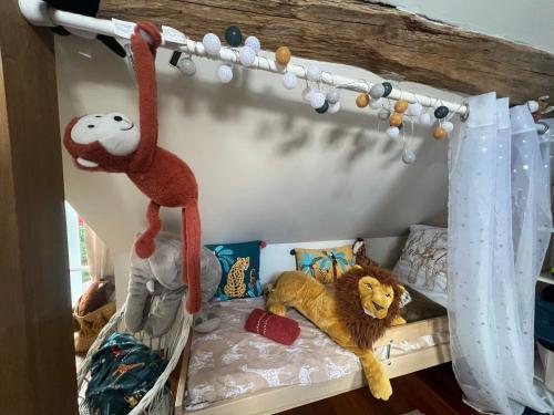 a bedroom with a bed with stuffed animals on it at gite Chezelle in Saint-Georges-sur-Cher