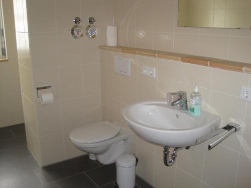 a bathroom with a sink and a toilet at Appartements Vanii in Rust