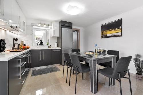 a kitchen with a table and chairs in a room at Echoes of Prinos in Metókhion Yianítsari