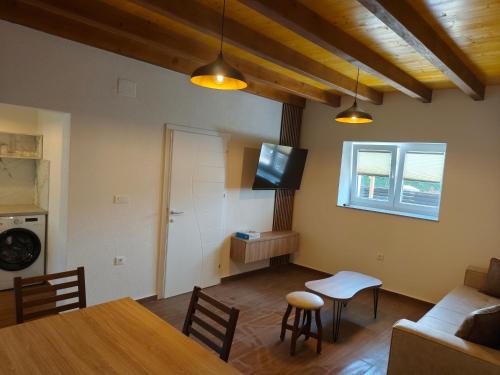 a living room with a table and a couch and a television at villa Tema 2 in Ohrid