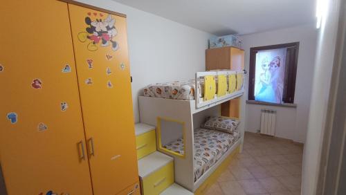 a bunk bed room with two bunk beds and a staircase at Claniland in Castelnuovo del Garda