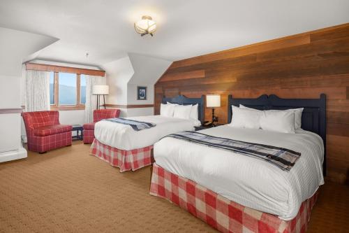 a hotel room with two beds and a chair at von Trapp Family Lodge & Resort in Stowe
